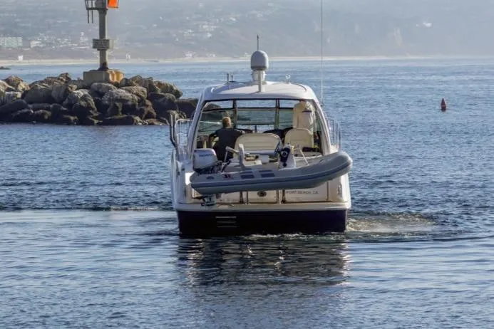 Hideout Yacht Photos Pics 2005 Sea Ray 390 Sundancer yacht navigating coastal waters near rocky shoreline.