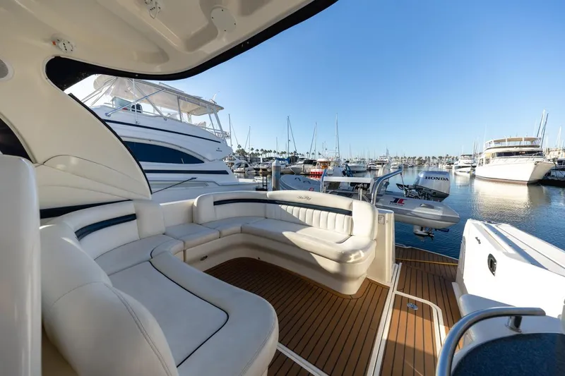 Hideout Yacht Photos Pics Luxurious 2005 Sea Ray 390 Sundancer yacht interior at marina, featuring elegant seating.
