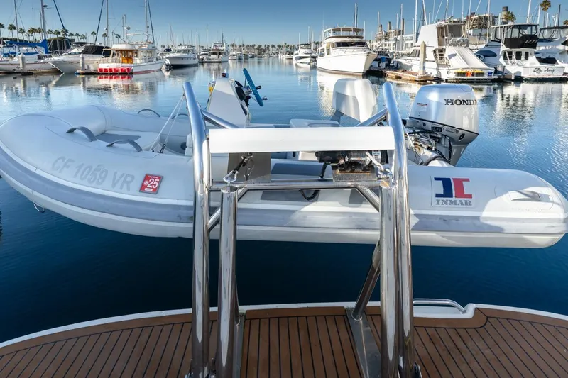 Hideout Yacht Photos Pics 2005 Sea Ray 390 Sundancer with dinghy in a marina, calm water, and surrounding boats.