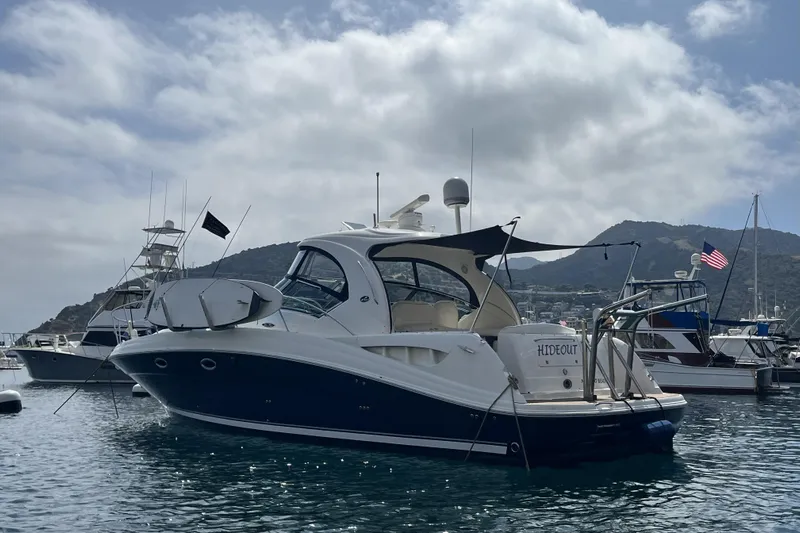 Hideout Yacht Photos Pics 2005 Sea Ray 390 Sundancer yacht docked in scenic marina with mountains.