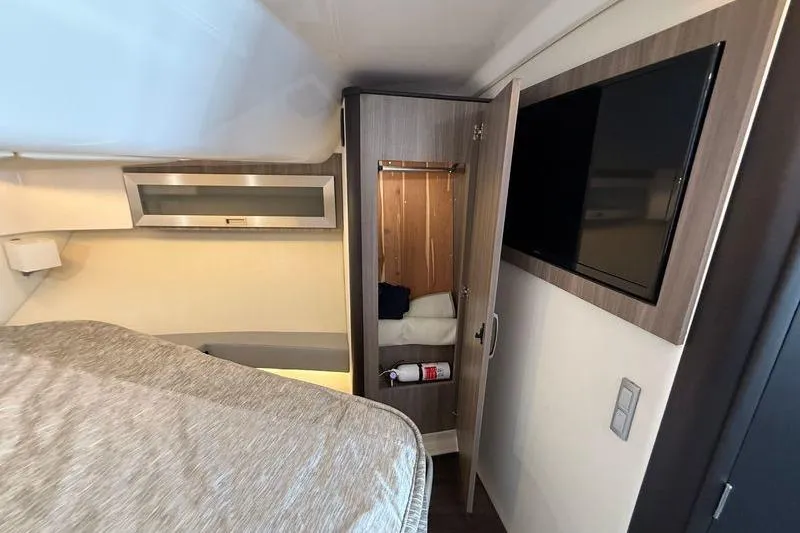  Yacht Photos Pics Interior of 2022 Regal 36 XO yacht with bed, closet, and TV.