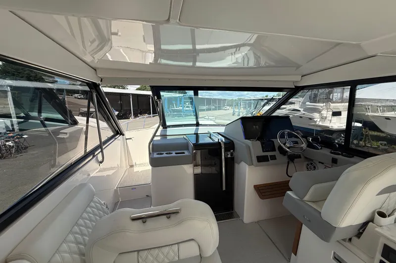  Yacht Photos Pics Interior of 2022 Regal 36 XO yacht, featuring modern helm and luxurious seating.