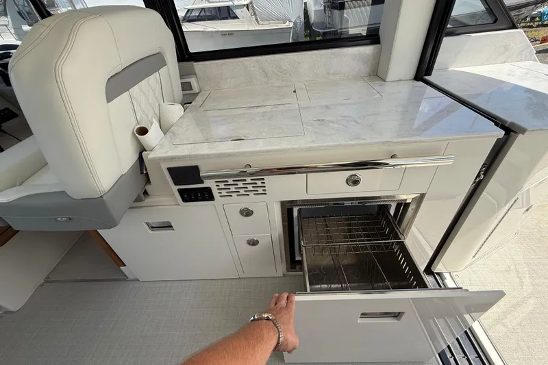  Yacht Photos Pics 2022 Regal 36 XO yacht interior with open drawer and modern kitchen amenities.