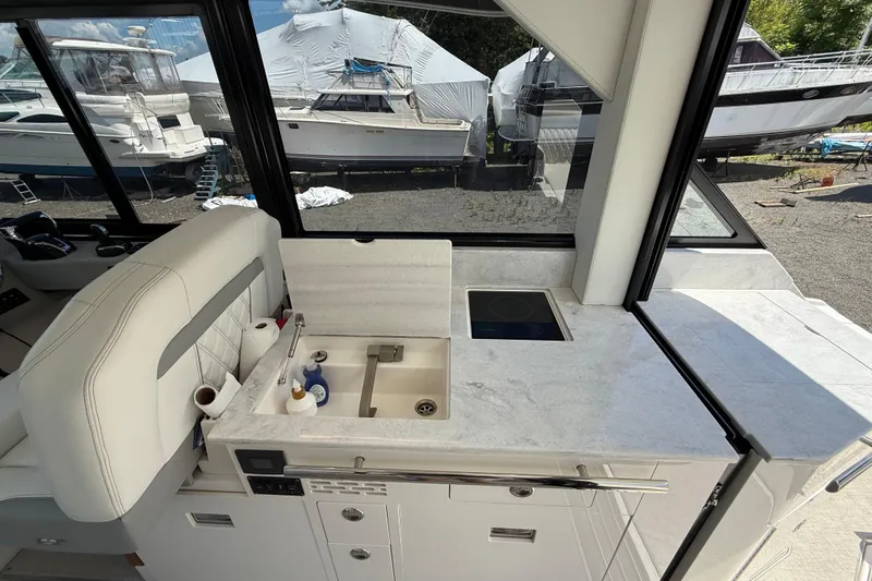  Yacht Photos Pics 2022 Regal 36 XO yacht interior with modern kitchenette and sleek design.