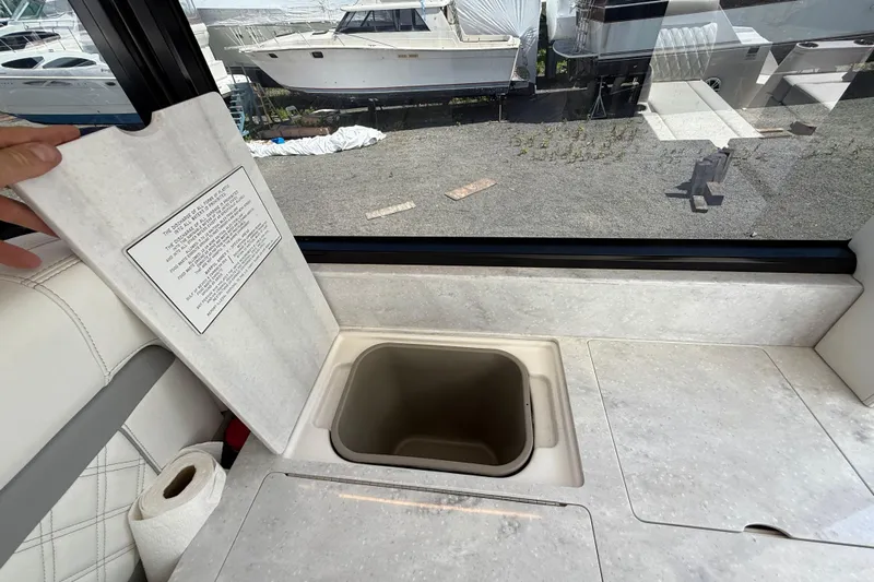  Yacht Photos Pics 2022 Regal 36 XO yacht interior with open storage compartment and window view.