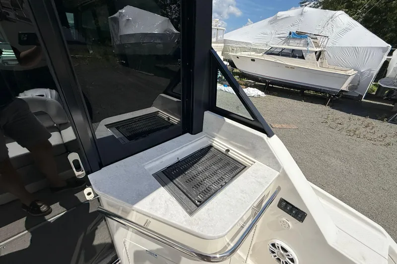  Yacht Photos Pics 2022 Regal 36 XO boat with outdoor grill and seating area.