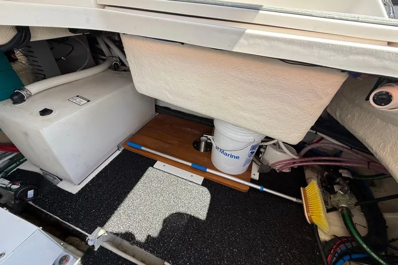  Yacht Photos Pics 2022 Regal 36 XO boat interior storage area with equipment and cleaning supplies.