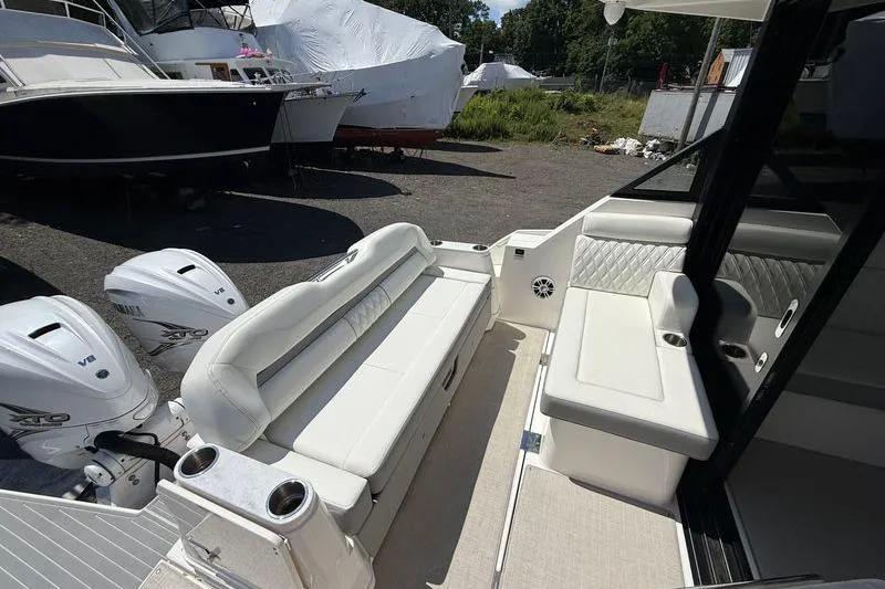  Yacht Photos Pics 2022 Regal 36 XO boat interior with white seating and twin outboard engines.