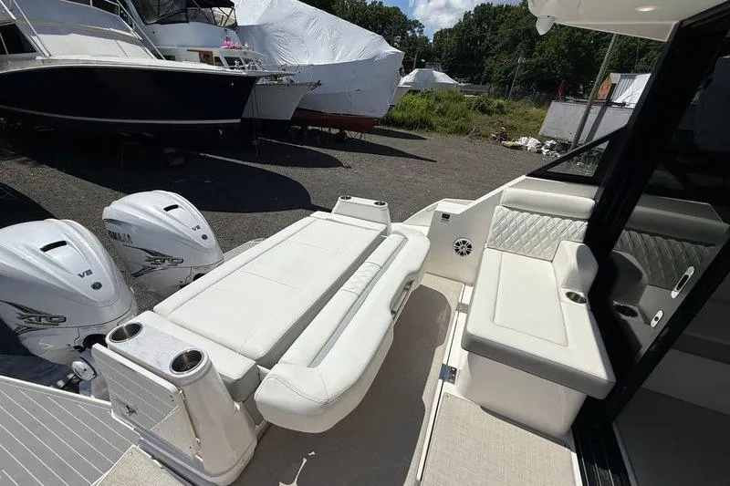  Yacht Photos Pics 2022 Regal 36 XO boat interior with seating and twin outboard engines.
