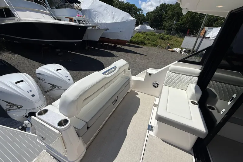  Yacht Photos Pics 2022 Regal 36 XO boat interior with Yamaha V8 engines, featuring white seating and cup holders.