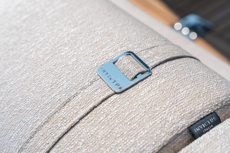  Yacht Photos Pics Soft beige fabric with Invictus TT550 2025 metal tag detail.