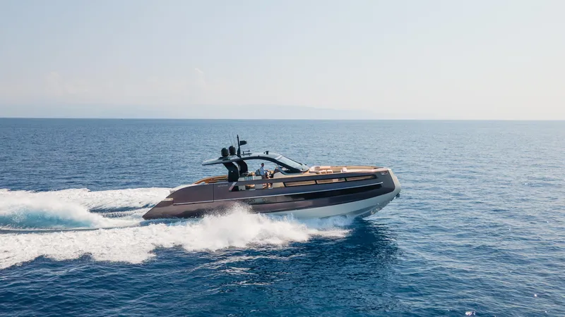  Yacht Photos Pics 2025 Invictus TT550 yacht cruising on open sea under clear sky.
