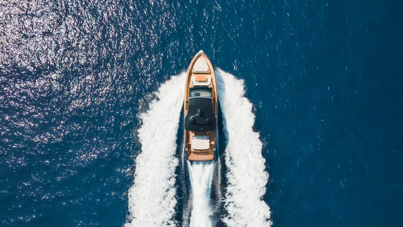  Yacht Photos Pics Aerial view of 2025 Invictus TT550 yacht cruising on blue ocean waters.