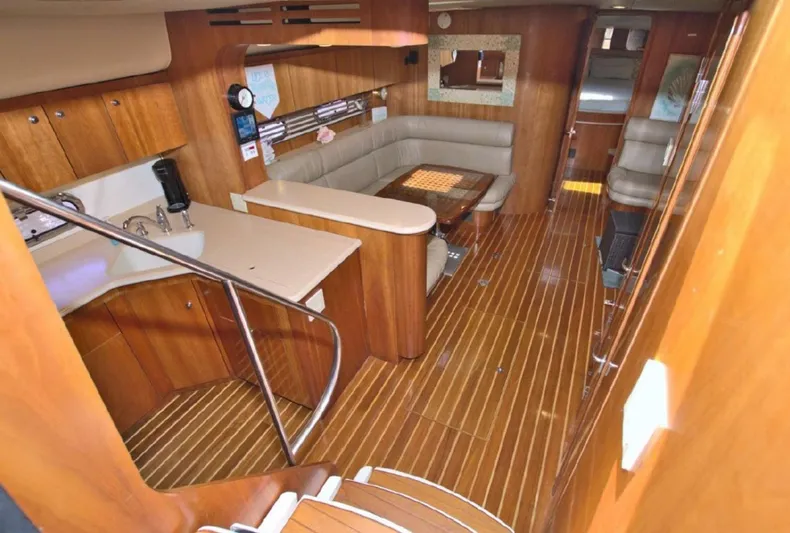 Sunshine Yacht Photos Pics Luxurious interior of 2000 Tiara Yachts 5200 Express with wood finish and seating area.