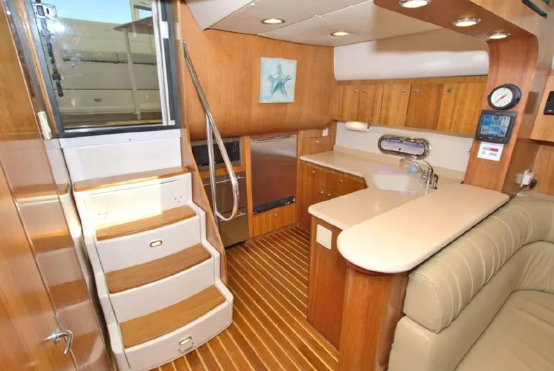 Sunshine Yacht Photos Pics Interior of 2000 Tiara Yachts 5200 Express, featuring a modern kitchen and wooden cabinetry.