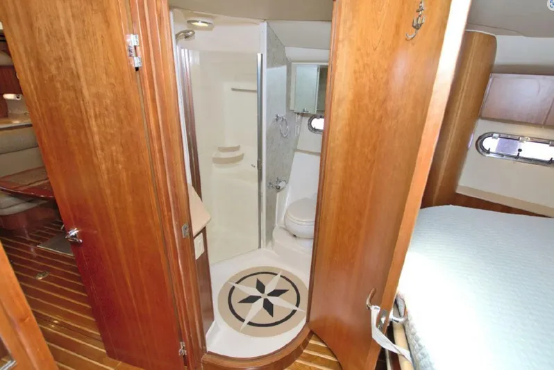 Sunshine Yacht Photos Pics Luxurious bathroom interior of 2000 Tiara Yachts 5200 Express with wooden accents.