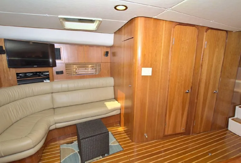 Sunshine Yacht Photos Pics Luxurious interior of 2000 Tiara Yachts 5200 Express with leather seating and wood paneling.