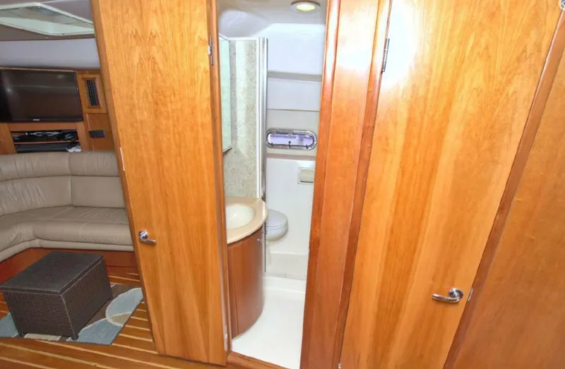 Sunshine Yacht Photos Pics Luxurious interior of 2000 Tiara Yachts 5200 Express with wood finish and cozy seating.