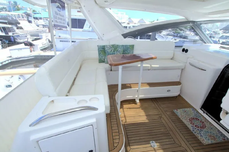 Sunshine Yacht Photos Pics Luxurious 2000 Tiara Yachts 5200 Express interior with white seating and wooden accents.