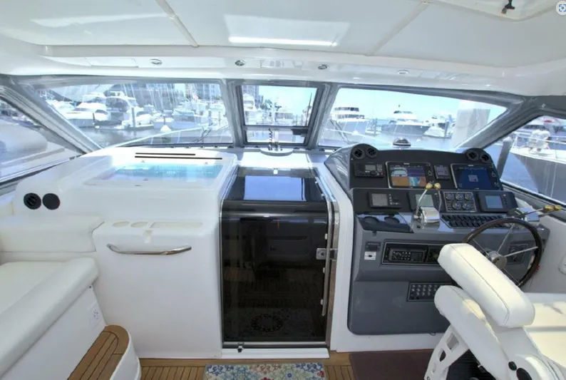 Sunshine Yacht Photos Pics Interior cockpit of 2000 Tiara Yachts 5200 Express, featuring modern navigation equipment and seating.