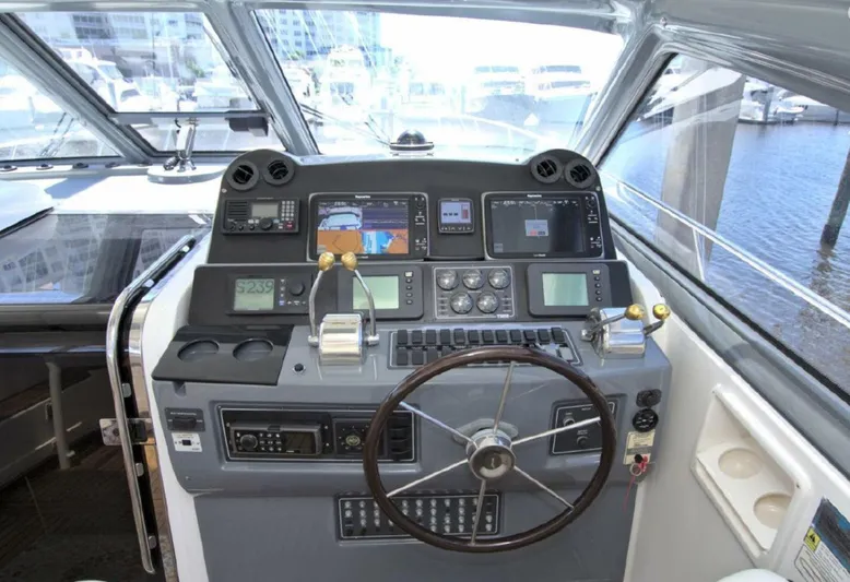 Sunshine Yacht Photos Pics Helm of 2000 Tiara Yachts 5200 Express with navigation instruments and steering wheel.