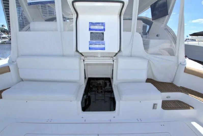 Sunshine Yacht Photos Pics 2000 Tiara Yachts 5200 Express interior with white seating and open hatch.