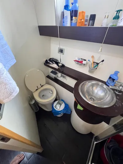  Yacht Photos Pics Compact bathroom in a 2006 Azimut 86S yacht with sink, toilet, and toiletries.