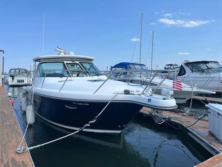  Yacht Photos Pics 2006 Tiara Yachts 3200 Open docked, featuring sleek design and American flag.