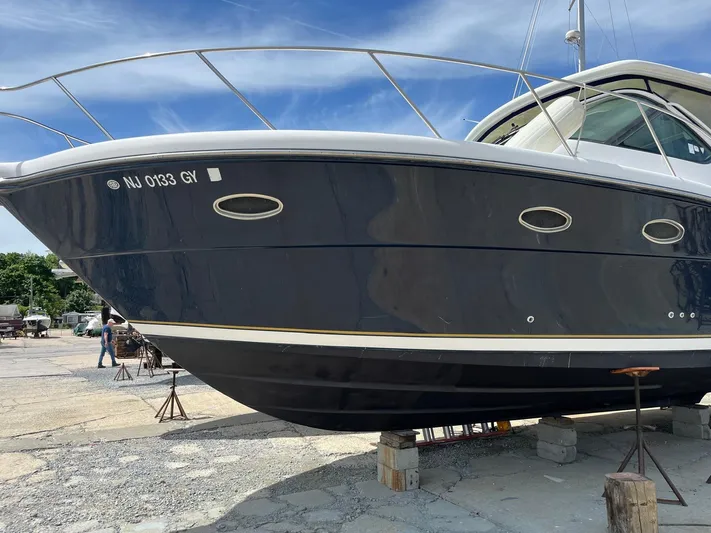  Yacht Photos Pics 2006 Tiara Yachts 3200 Open on dry dock, blue hull, sunny day.