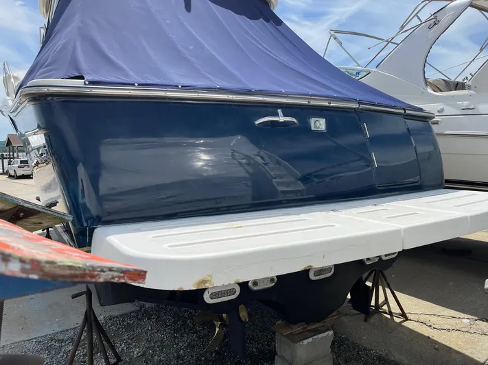  Yacht Photos Pics 2006 Tiara Yachts 3200 Open with blue cover, docked on land.