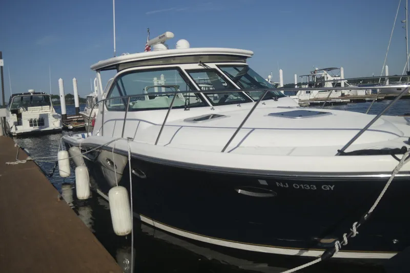  Yacht Photos Pics 2006 Tiara Yachts 3200 Open docked at marina, side view.