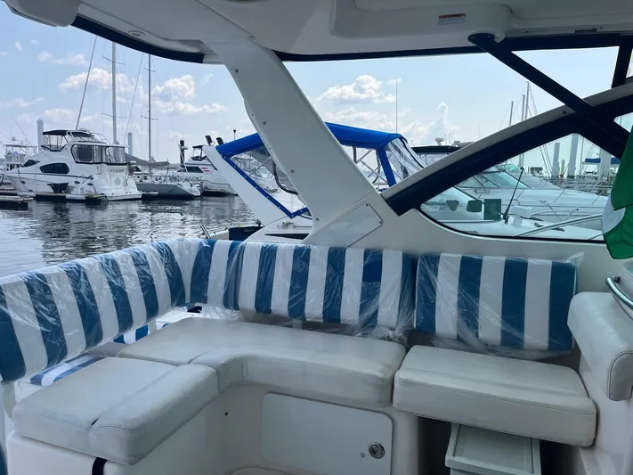  Yacht Photos Pics 2006 Tiara Yachts 3200 Open with striped seating, docked at a marina.