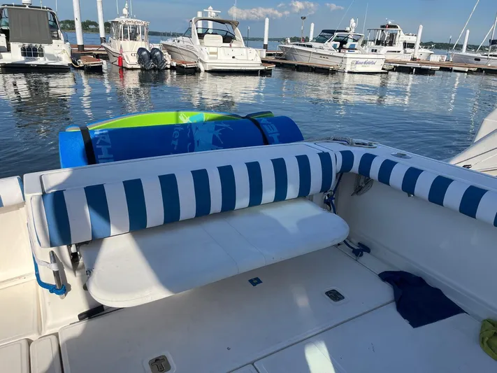  Yacht Photos Pics 2006 Tiara Yachts 3200 Open with striped seating at a marina.