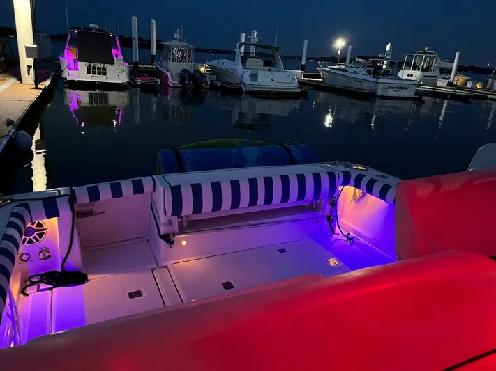  Yacht Photos Pics 2006 Tiara Yachts 3200 Open with colorful deck lights at night in marina.