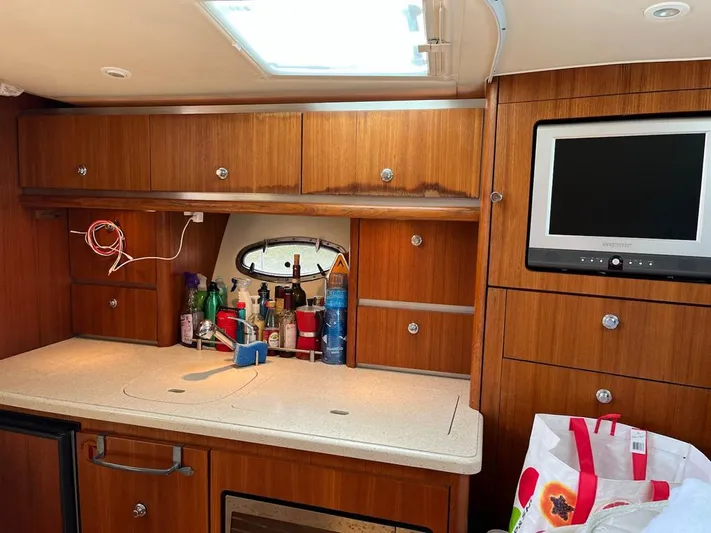  Yacht Photos Pics 2006 Tiara Yachts 3200 Open interior with wooden cabinets and a small TV.