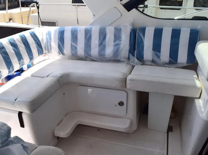  Yacht Photos Pics 2006 Tiara Yachts 3200 Open interior with striped seating and storage compartment.