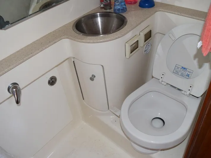  Yacht Photos Pics Compact bathroom in 2006 Tiara Yachts 3200 Open, featuring a sink and toilet.