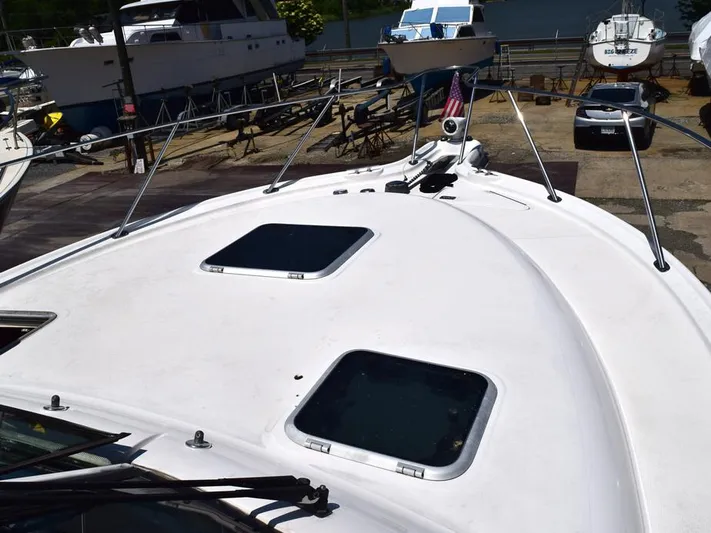  Yacht Photos Pics 2006 Tiara Yachts 3200 Open boat deck with hatches, docked in a marina.