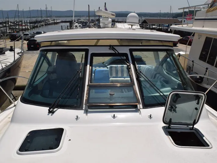  Yacht Photos Pics 2006 Tiara Yachts 3200 Open at marina, showcasing windshield and open hatch.