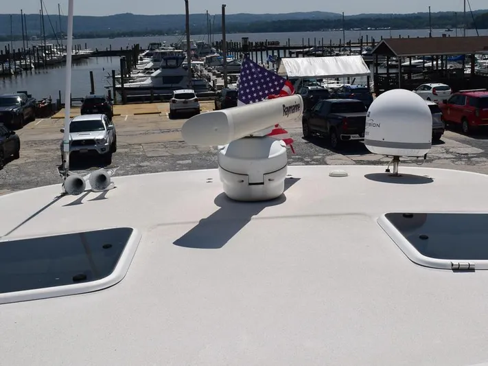  Yacht Photos Pics 2006 Tiara Yachts 3200 Open at marina with radar and American flag.