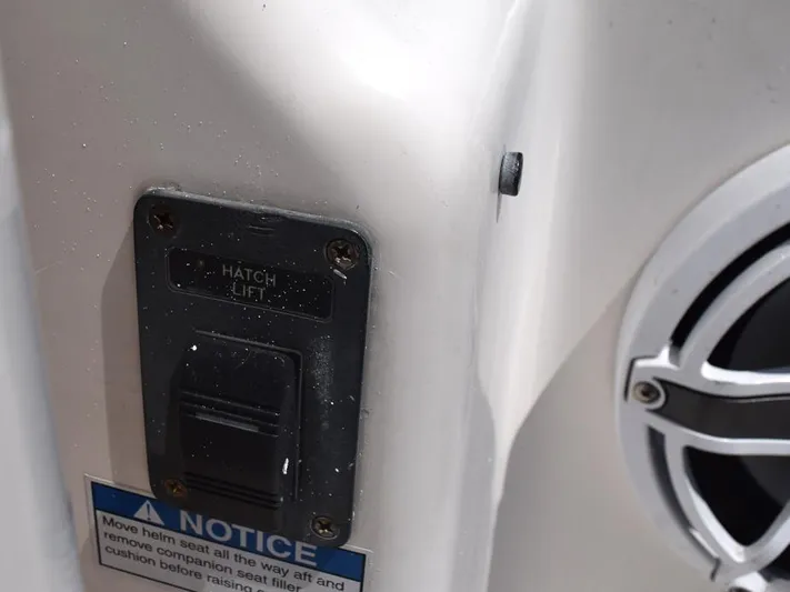  Yacht Photos Pics Hatch lift switch on 2006 Tiara Yachts 3200 Open, with notice label and speaker detail.