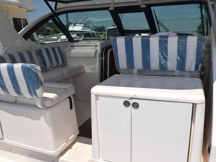  Yacht Photos Pics 2006 Tiara Yachts 3200 Open interior with striped seating and white cabinetry.