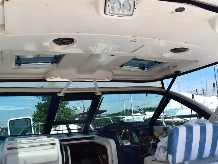  Yacht Photos Pics 2006 Tiara Yachts 3200 Open cockpit with striped seating and control panel.