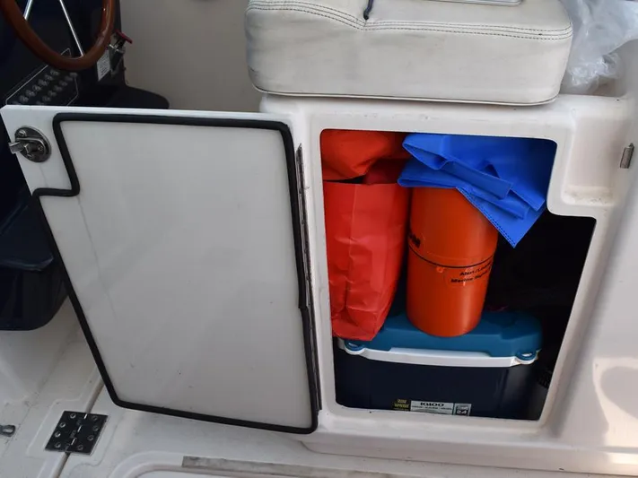  Yacht Photos Pics Open storage compartment on 2006 Tiara Yachts 3200 Open, containing safety gear and cooler.