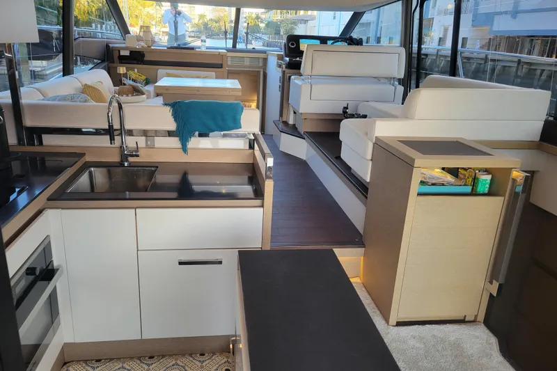 Elles II Yacht Photos Pics Luxurious interior of a 2018 Prestige 520 yacht featuring modern kitchen and seating area.