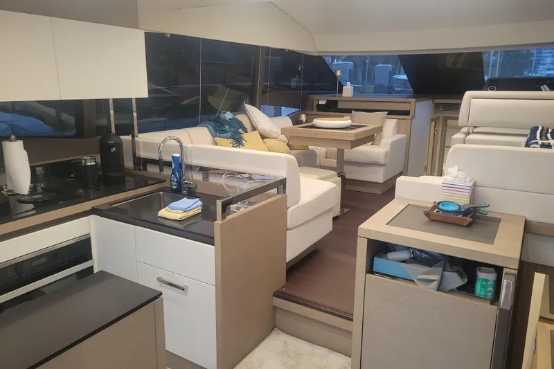 Elles II Yacht Photos Pics Luxurious interior of a 2018 Prestige 520 yacht with modern kitchen and seating area.