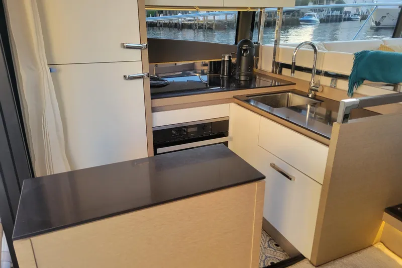 Elles II Yacht Photos Pics Modern kitchen interior on a 2018 Prestige 520 yacht, featuring sleek cabinetry and appliances.