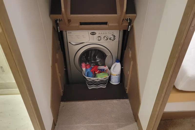Elles II Yacht Photos Pics Laundry area in 2018 Prestige 520 yacht with washing machine and cleaning supplies.