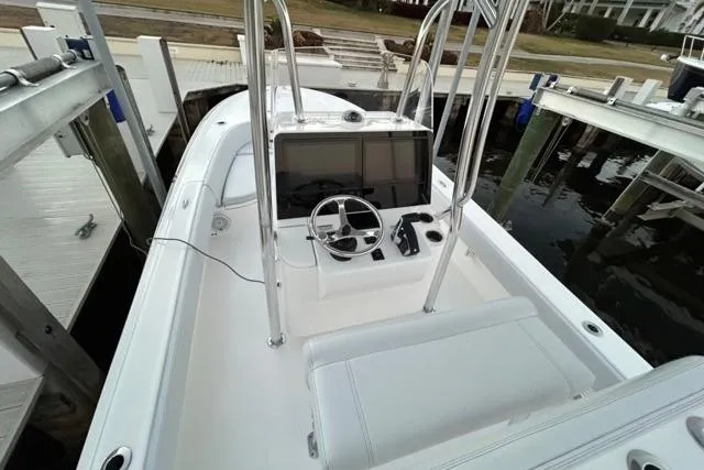  Yacht Photos Pics 2025 Contender 26 Bay boat with sleek console and modern controls at dock.