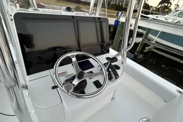  Yacht Photos Pics Helm of 2025 Contender 26 Bay boat with dual screens and steering wheel.